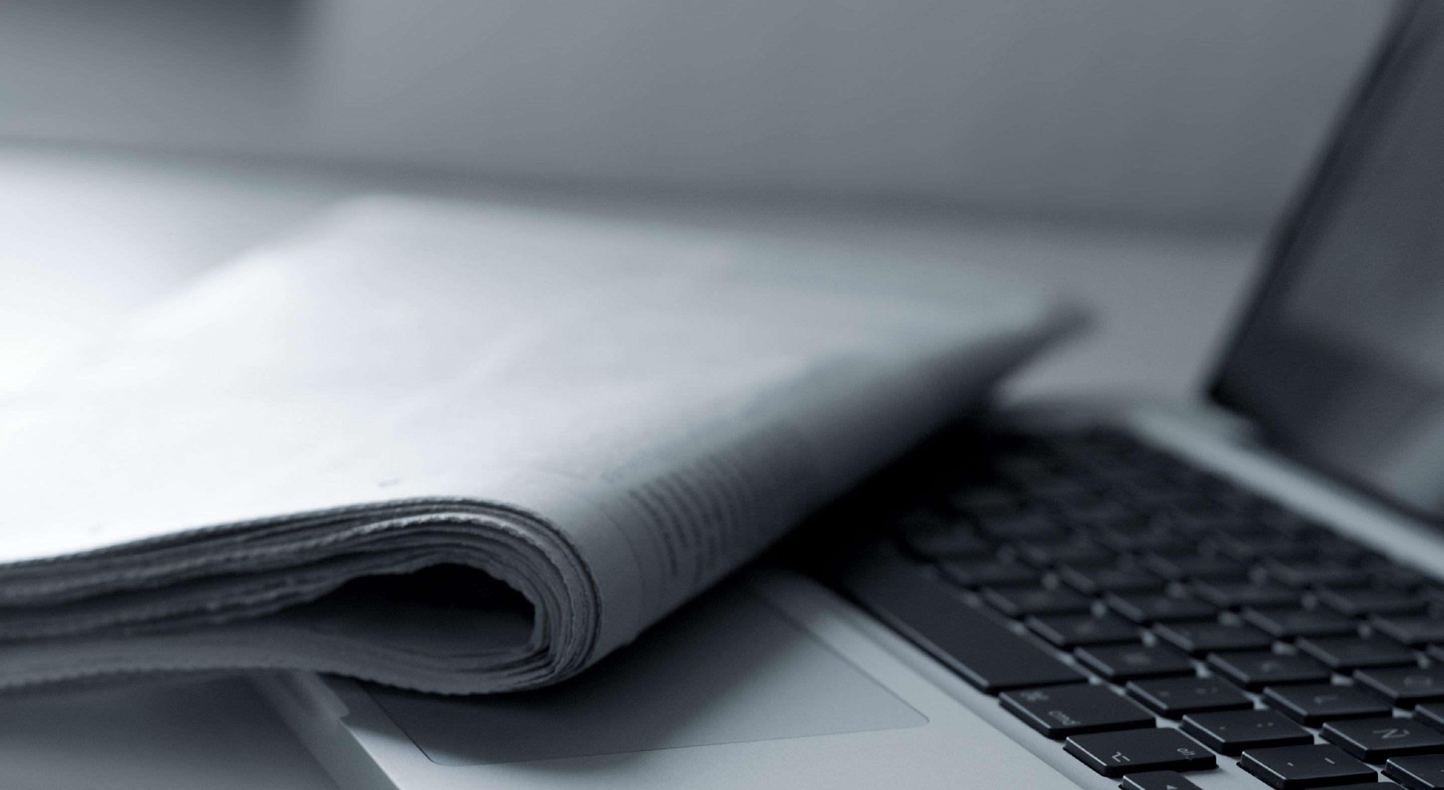 Work laptop and a notebook on a table dimly lit