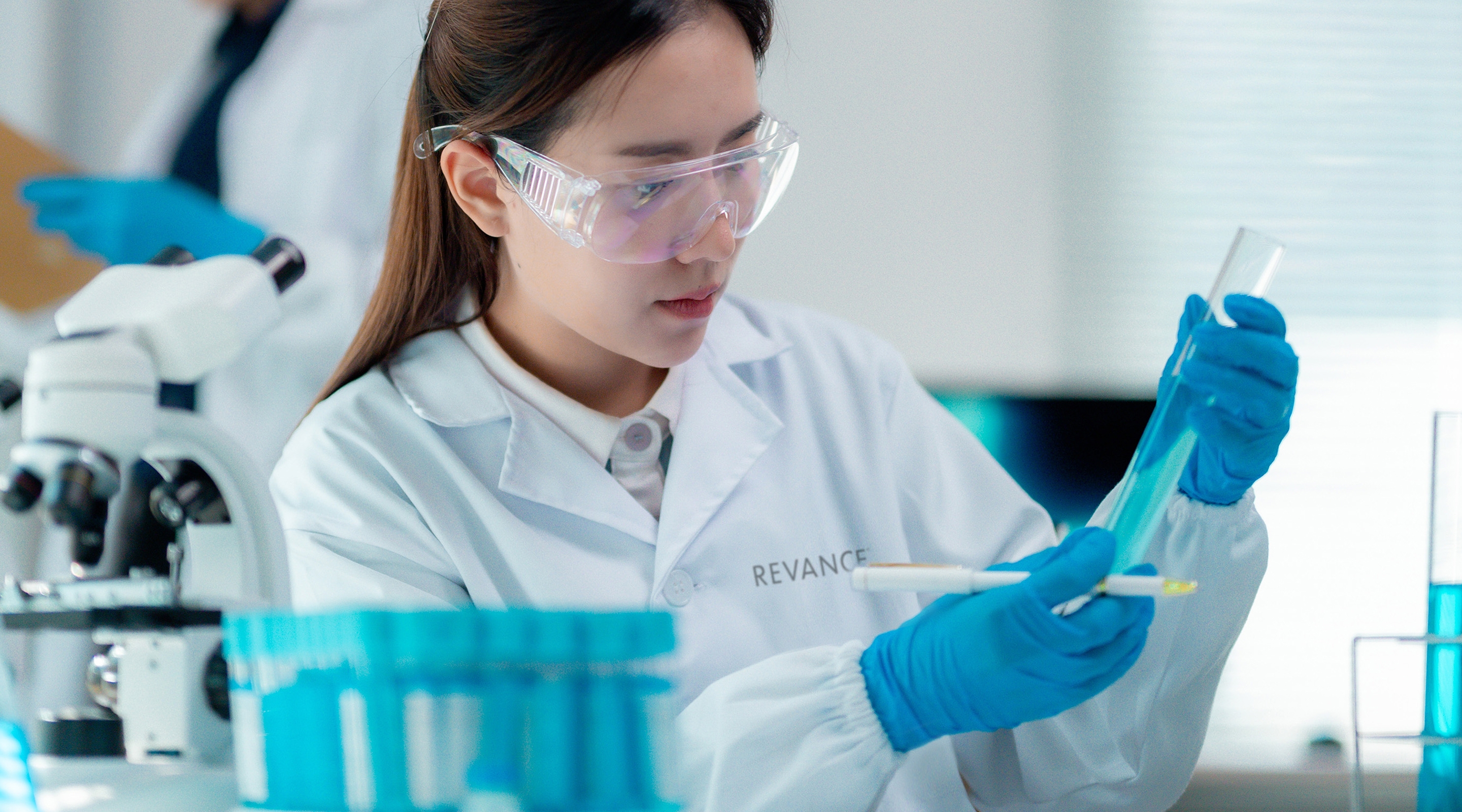 Chemist in a lab, working with a test tube